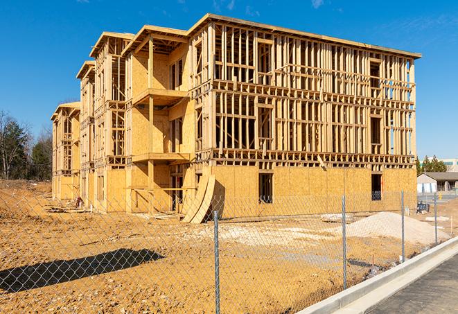 a temporary chain link fence locking away a building under renovation, serving as a security tool in Channahon, IL